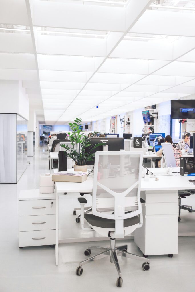 pexels-photo-3778622-3778622-1 Bright modern office interior with desks, chairs, and computers in an open-plan workspace.